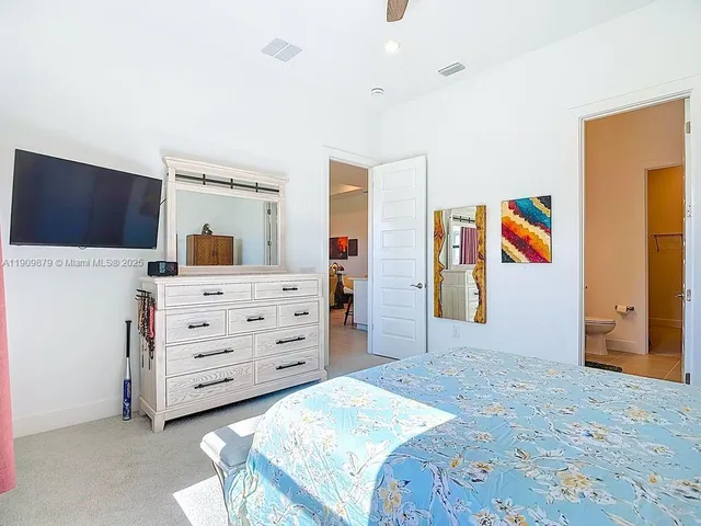 a bedroom with a bed and a dresser