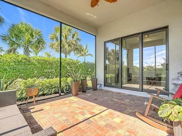 a spacious bedroom with a large window and table