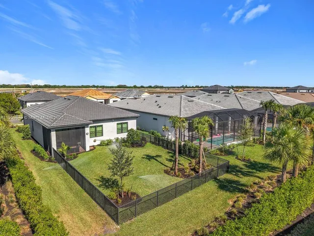 a view of a patio with a table and chairs under an umbrella