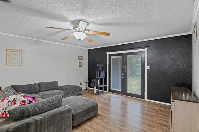 a living room with furniture and a ceiling fan