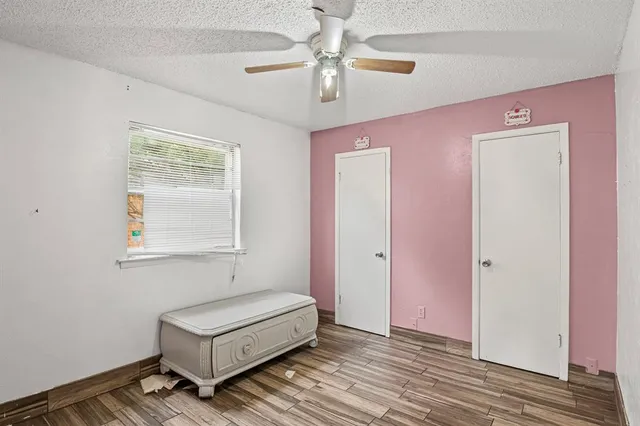 a bedroom with a bed and a ceiling fan