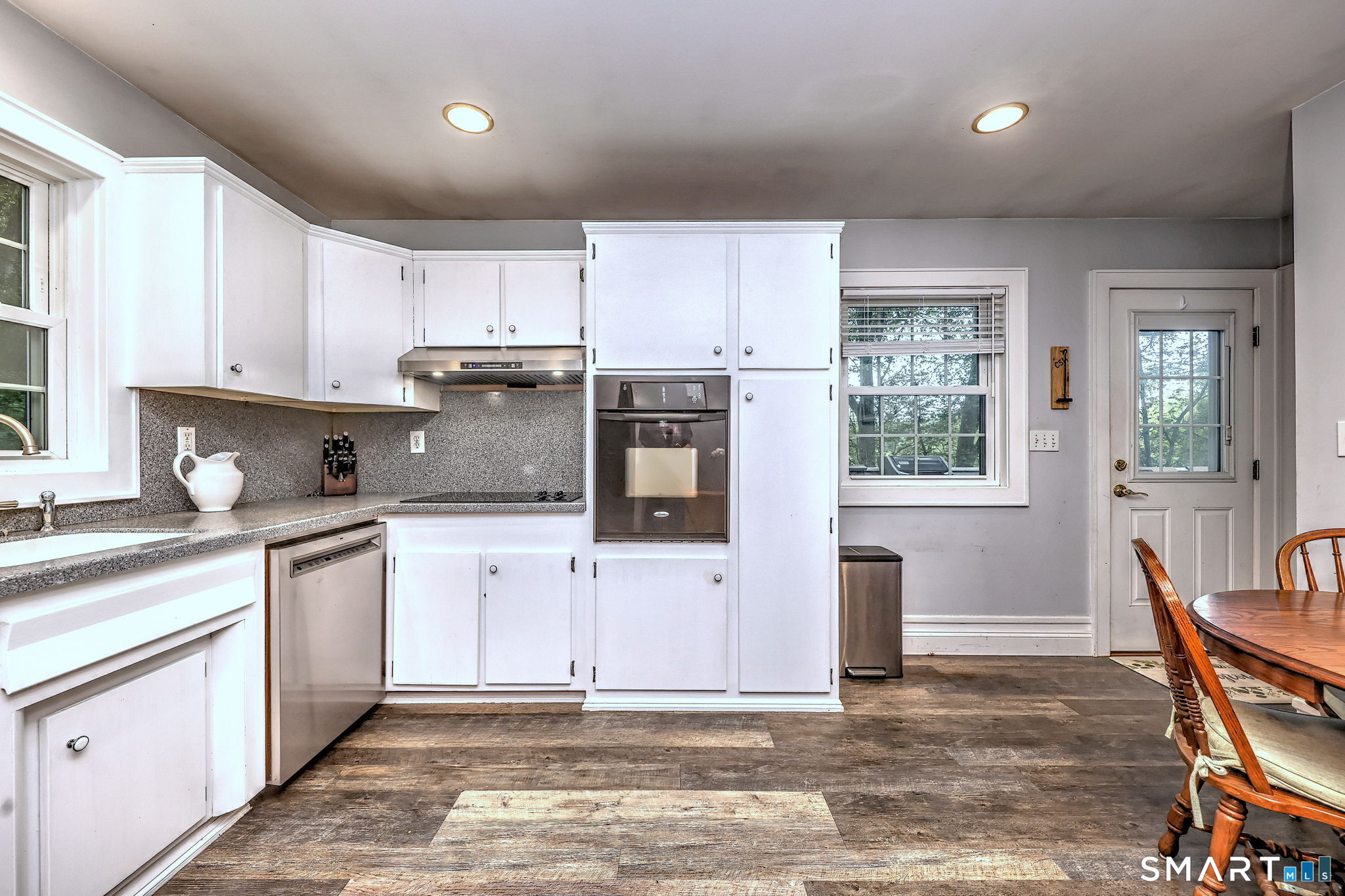 265 Shelter Rock Road Fairfield, CT 06825 - Photo 12 of 32 Easy to entertain in this well-appointed kitchen. Cooktop with hood and separate wall oven. New dishwasher 2026.