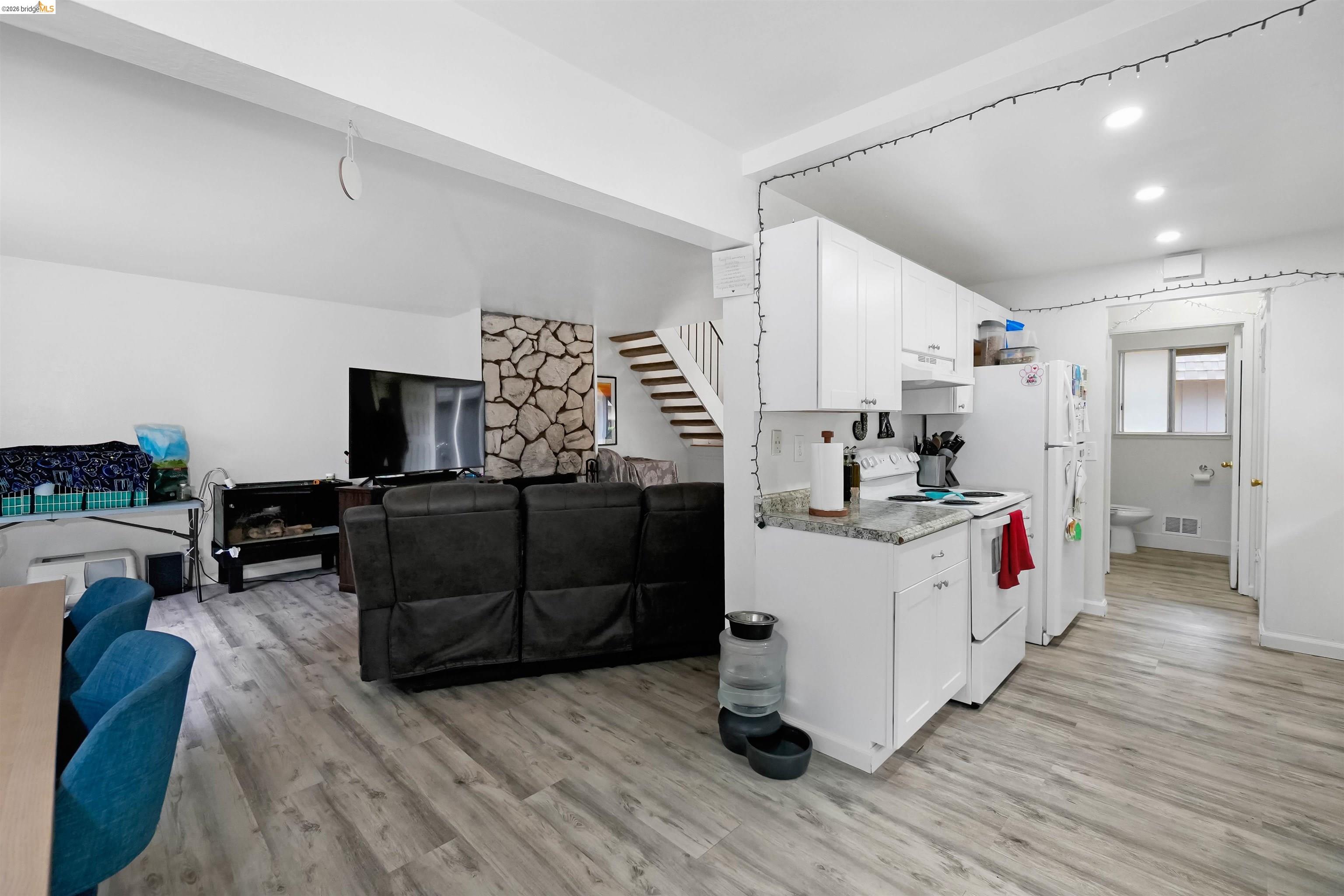 1066 San Miguel Road Concord, CA 94518 - Photo 59 of 59 Kitchen with white range with electric stovetop, open floor plan, white cabinets, light wood finished floors, and recessed lighting