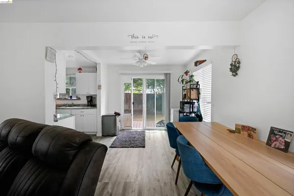 a dining room with furniture and wooden floor