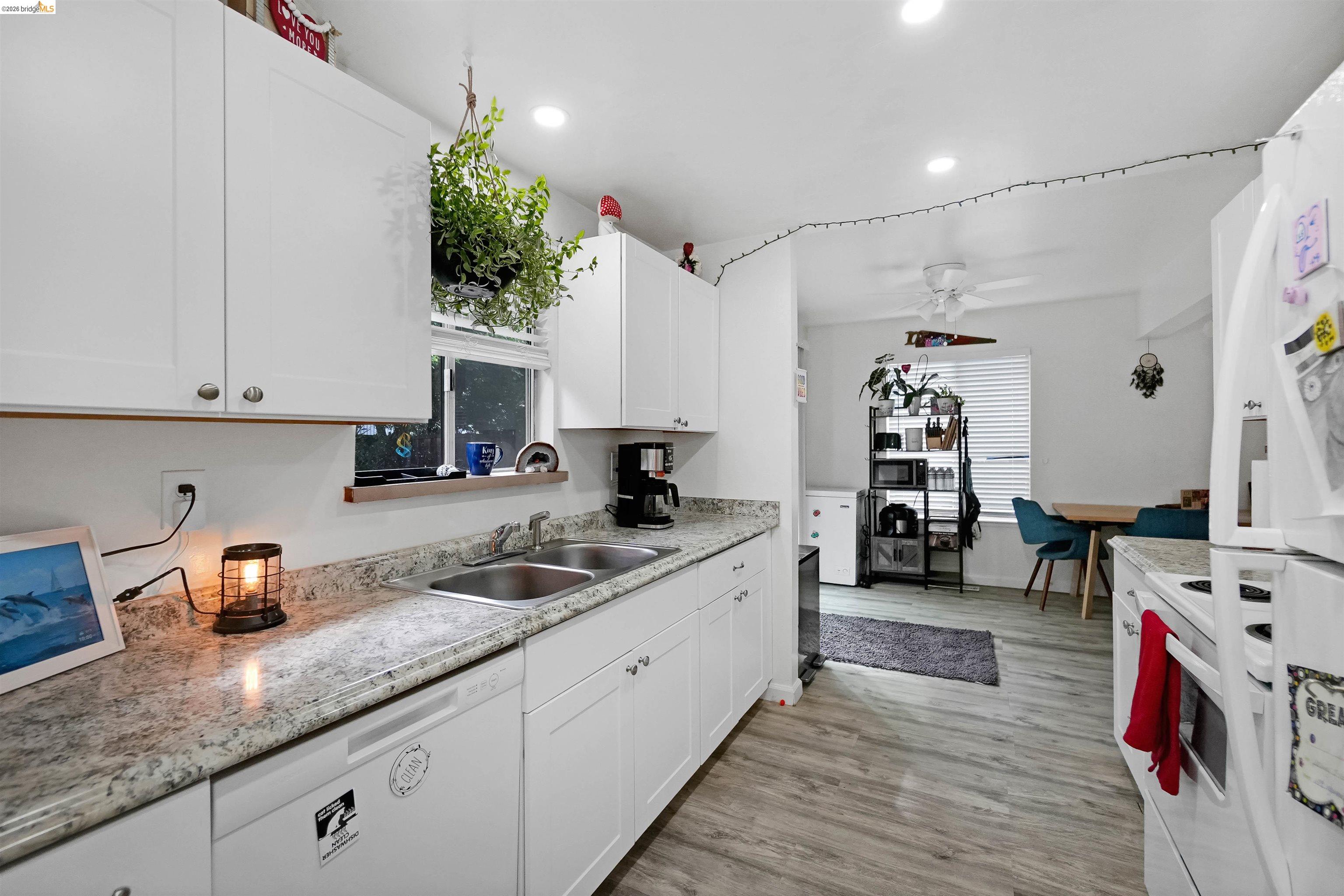 1066 San Miguel Road Concord, CA 94518 - Photo 19 of 59 Kitchen with white appliances, white cabinets, plenty of natural light, light wood-style floors, and recessed lighting