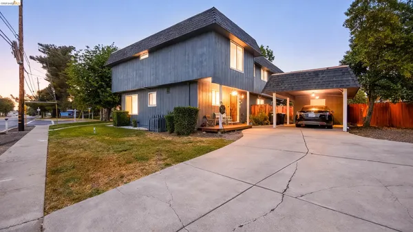 a front view of a house with a yard and porch