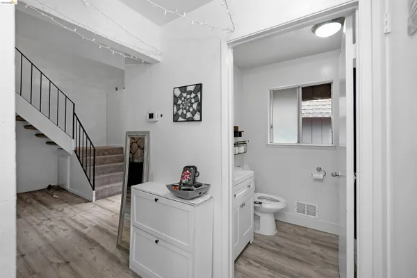 a bathroom with a sink mirror toilet and vanity