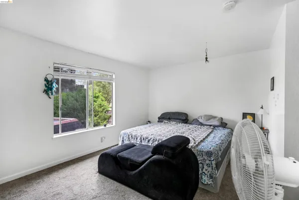 a bedroom with a bed and furniture