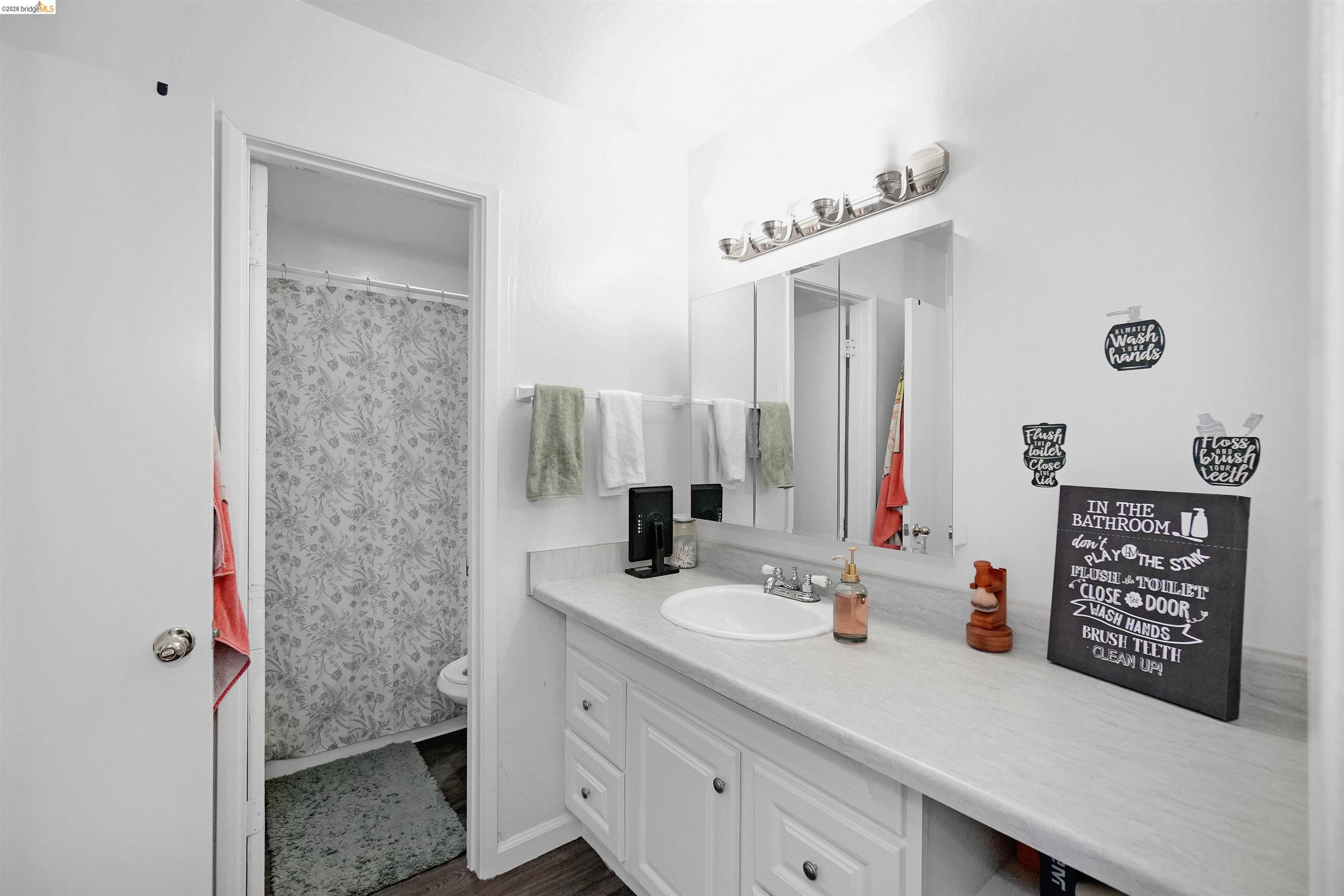 1066 San Miguel Road Concord, CA 94518 - Photo 30 of 59 Bathroom featuring vanity and dark wood-style flooring