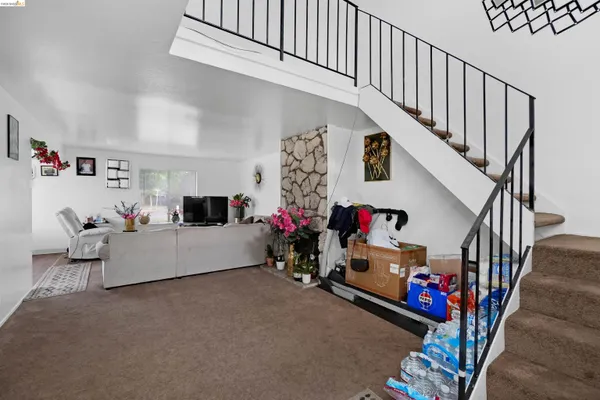 a kitchen with stainless steel appliances a stove a sink a refrigerator cabinets and wooden floor