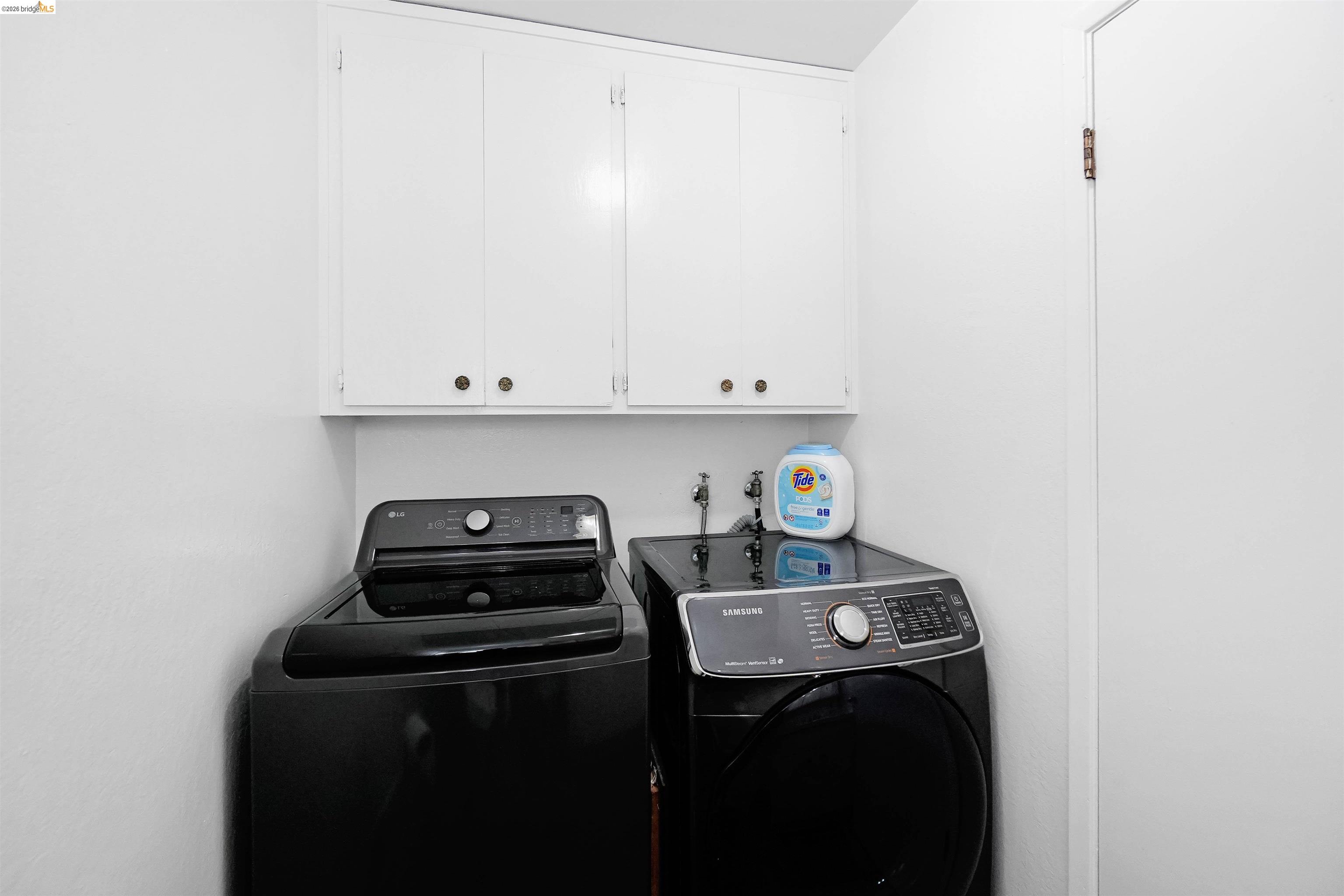 1066 San Miguel Road Concord, CA 94518 - Photo 47 of 59 Laundry room with cabinet space and washer and dryer