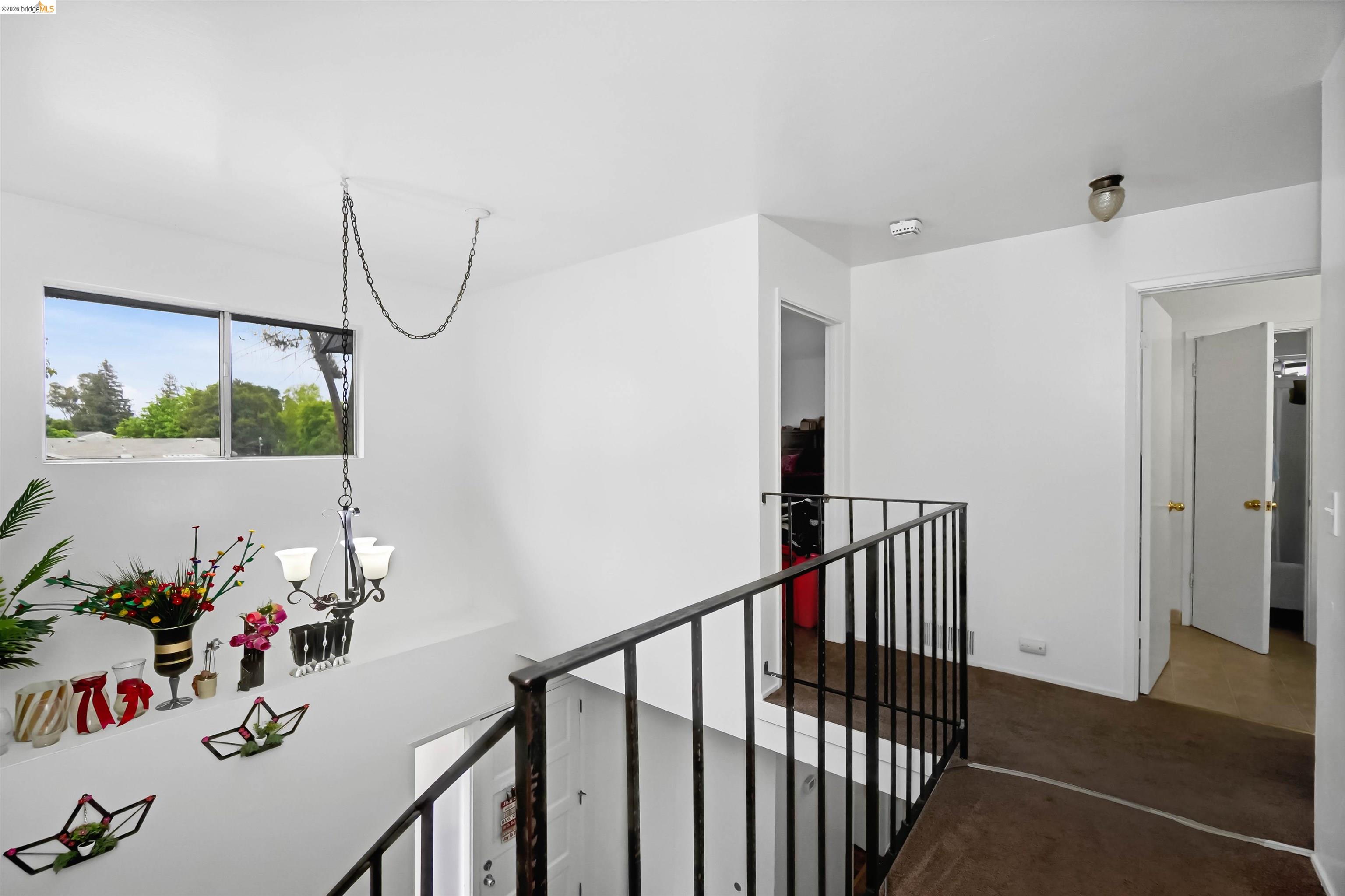 1066 San Miguel Road Concord, CA 94518 - Photo 49 of 59 Corridor featuring a chandelier, an upstairs landing, and carpet floors