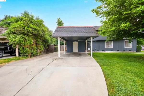 a view of house with a backyard
