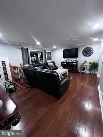 a living room with furniture a dining table and a piano