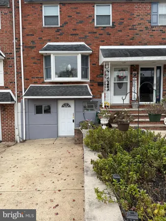 front view of a brick house with a yard