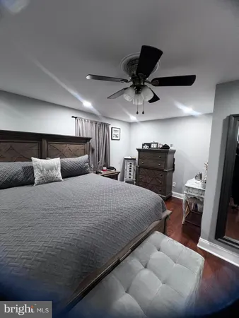 a bedroom with a bed and a television