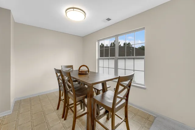 a view of a dining room with furniture and chandelier
