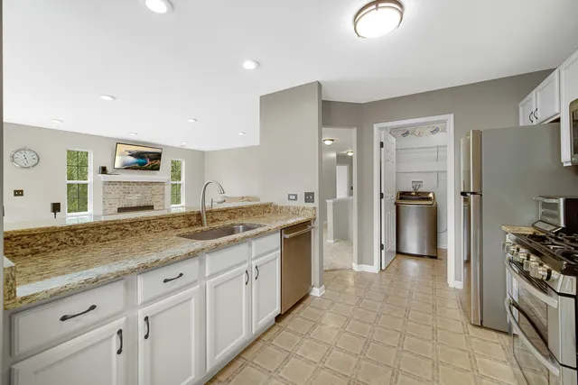 a large bathroom with a granite countertop double vanity sink a mirror and a shower