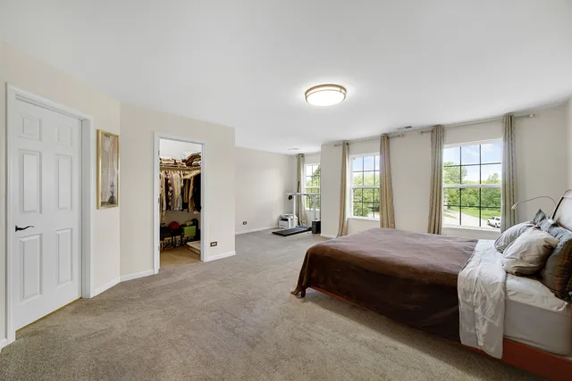 a spacious bedroom with a bed and a couch