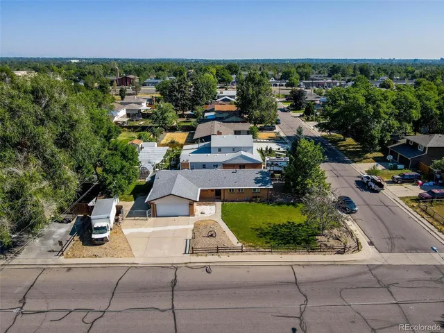 an aerial view of a house with a yard