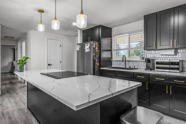 a kitchen with a table chairs and chandelier
