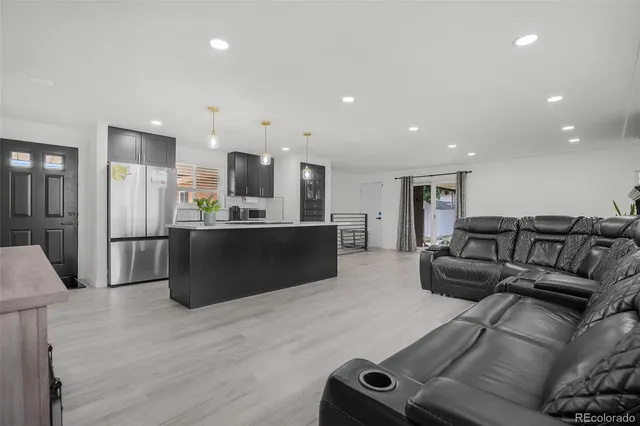 a living room with a couch and a wooden floor