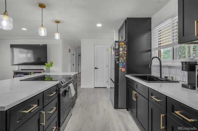 a kitchen with a sink stove and refrigerator