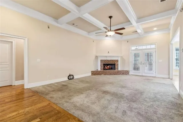 a kitchen with stainless steel appliances granite countertop a refrigerator a oven a sink and a dining table with wooden floor