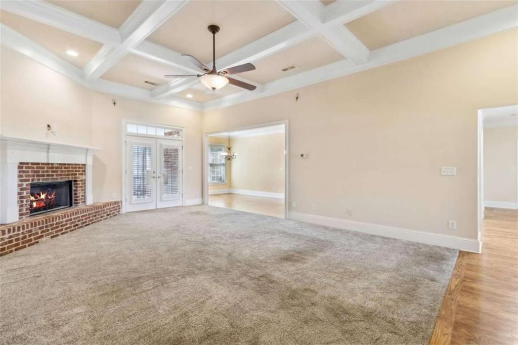 94 Appalachee Church Road Auburn, GA 30011 - Photo 18 of 66 a view of an empty room with chandelier fan and fireplace