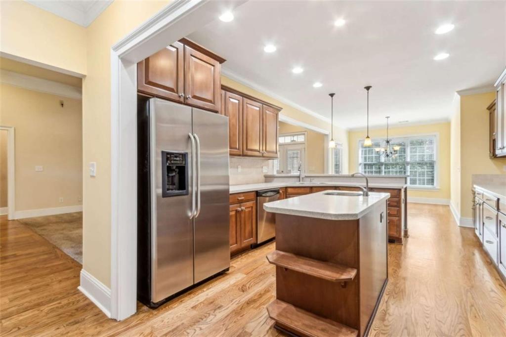 94 Appalachee Church Road Auburn, GA 30011 - Photo 21 of 66 a kitchen with stainless steel appliances granite countertop a refrigerator a oven a sink and a dining table with wooden floor