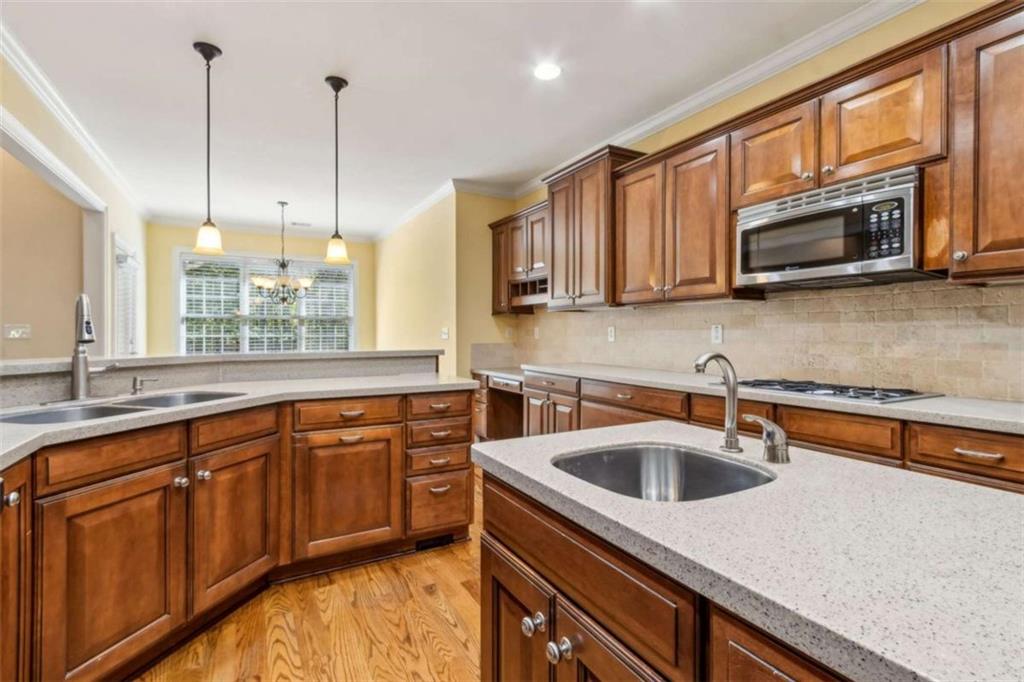 94 Appalachee Church Road Auburn, GA 30011 - Photo 24 of 66 a kitchen with stainless steel appliances granite countertop a sink a microwave and wooden cabinets