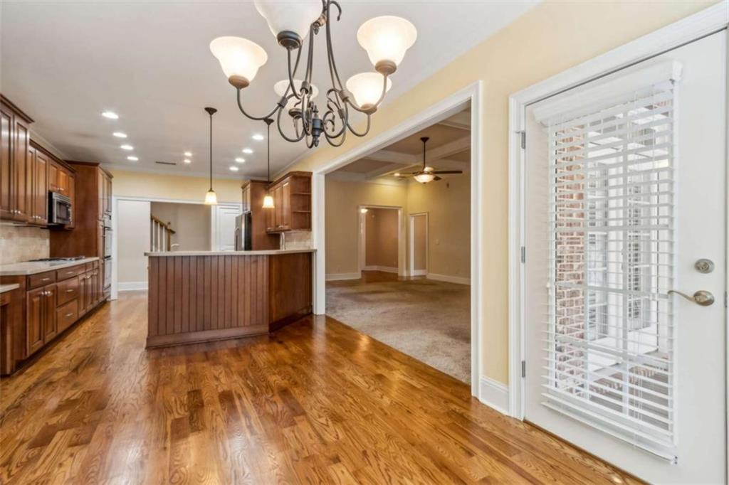 94 Appalachee Church Road Auburn, GA 30011 - Photo 30 of 66 a view of a big room with wooden floor and a kitchen