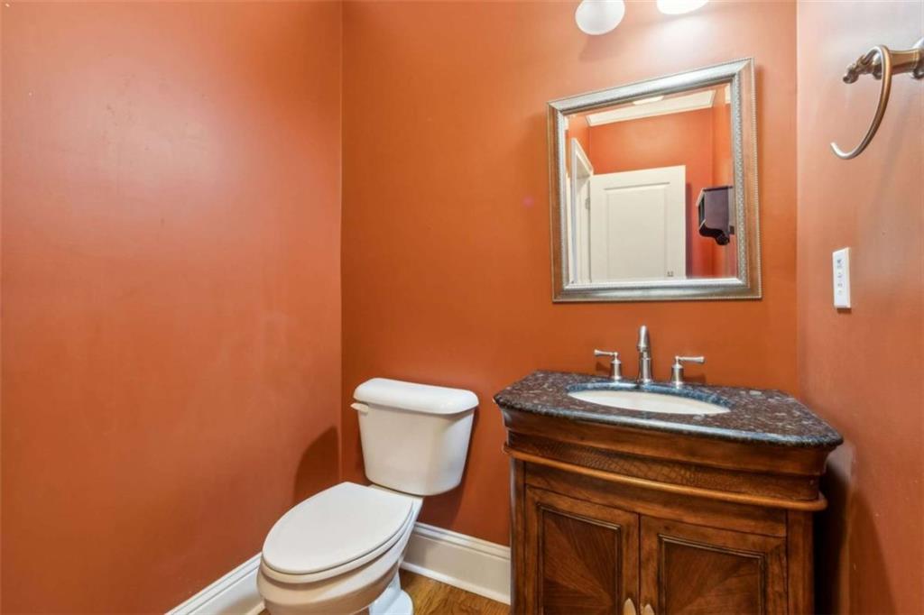 94 Appalachee Church Road Auburn, GA 30011 - Photo 31 of 66 a bathroom with a toilet a sink and mirror