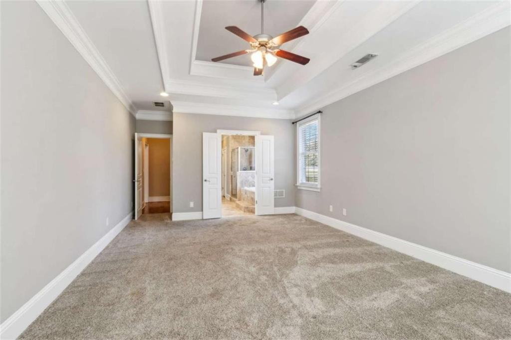 94 Appalachee Church Road Auburn, GA 30011 - Photo 35 of 66 an empty room with chandelier fan and windows