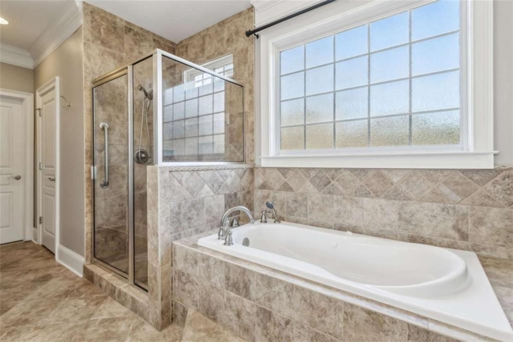 94 Appalachee Church Road Auburn, GA 30011 - Photo 37 of 66 a bathroom with a bathtub and shower