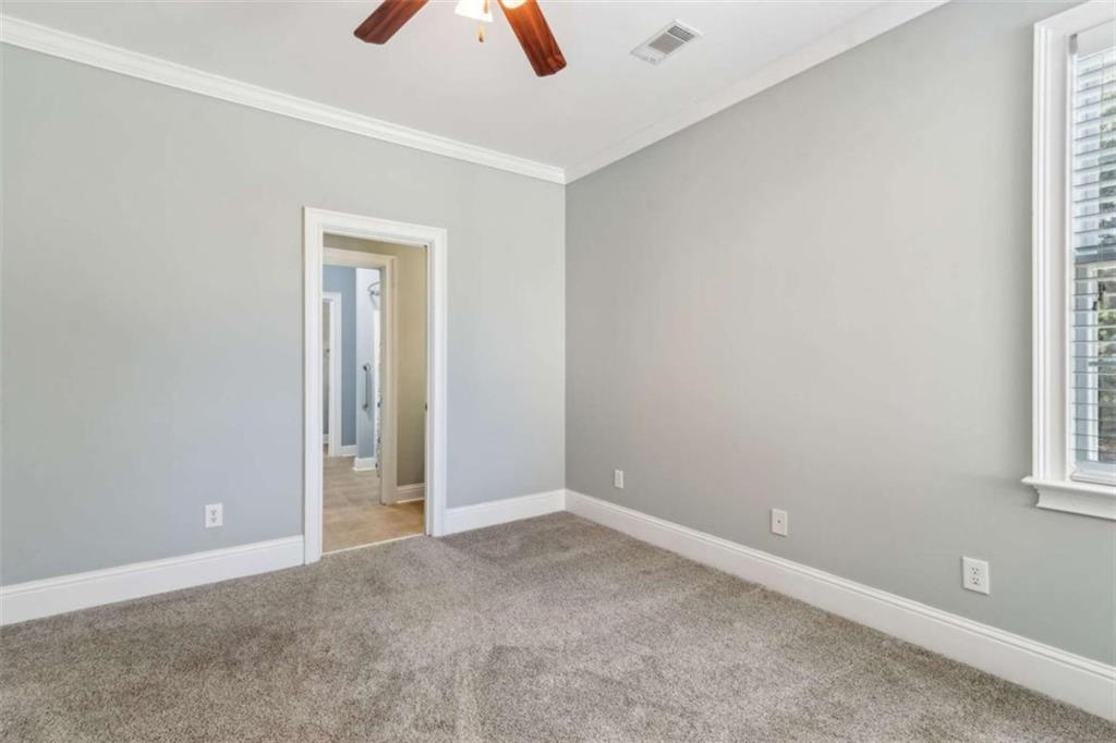 94 Appalachee Church Road Auburn, GA 30011 - Photo 42 of 66 an empty room with ceiling fan and window