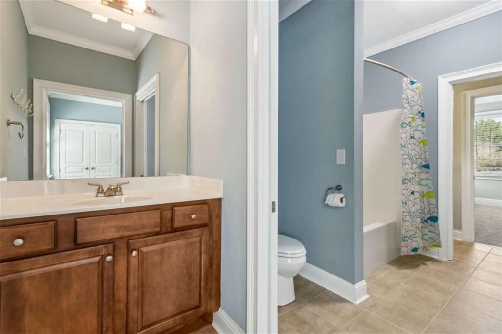 94 Appalachee Church Road Auburn, GA 30011 - Photo 44 of 66 a spacious bathroom with a granite countertop sink toilet and shower