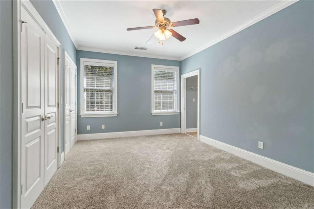 94 Appalachee Church Road Auburn, GA 30011 - Photo 46 of 66 an empty room with windows and chandelier fan