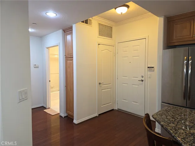 a kitchen with stainless steel appliances granite countertop a stove refrigerator and microwave