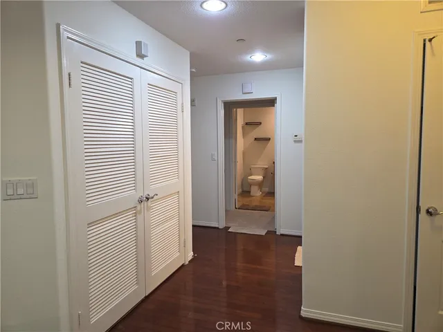 a view of a hallway with wooden floor