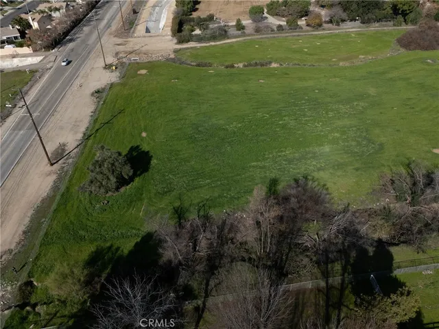 a view of a lush green hillside and houses