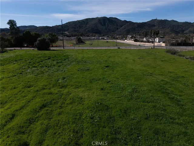 a view of a lush green hillside and houses