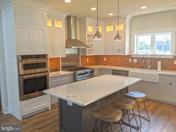 a kitchen with granite countertop a stove and a sink