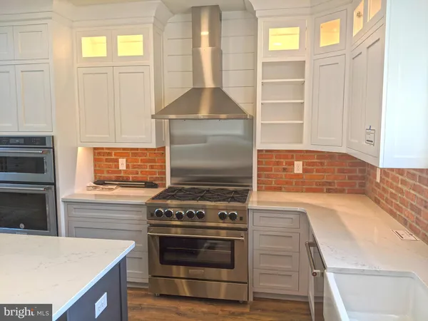 a kitchen with cabinets appliances and a window
