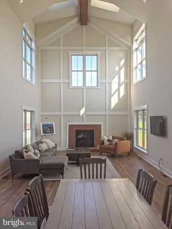 a living room with furniture a fireplace and a large window