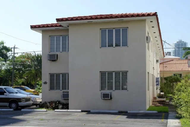 front view of house with a yard and a car park in front of it