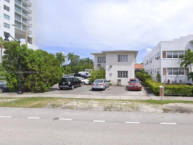 a kitchen with cabinets a refrigerator and a sink