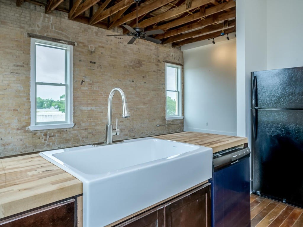 a kitchen with a sink a stove and a refrigerator