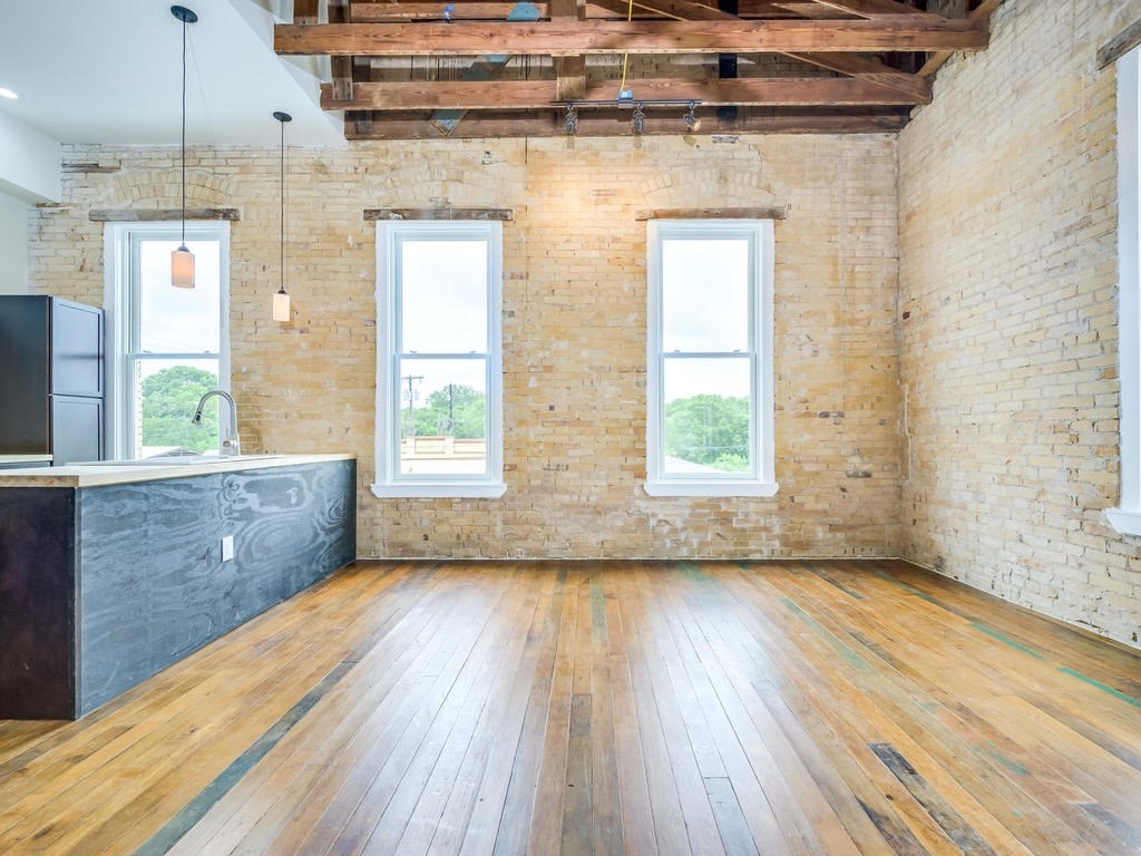110 South Main Street, Unit 206 Elgin, TX 78621 - Photo 15 of 20 a view of an empty room with wooden floor and a window