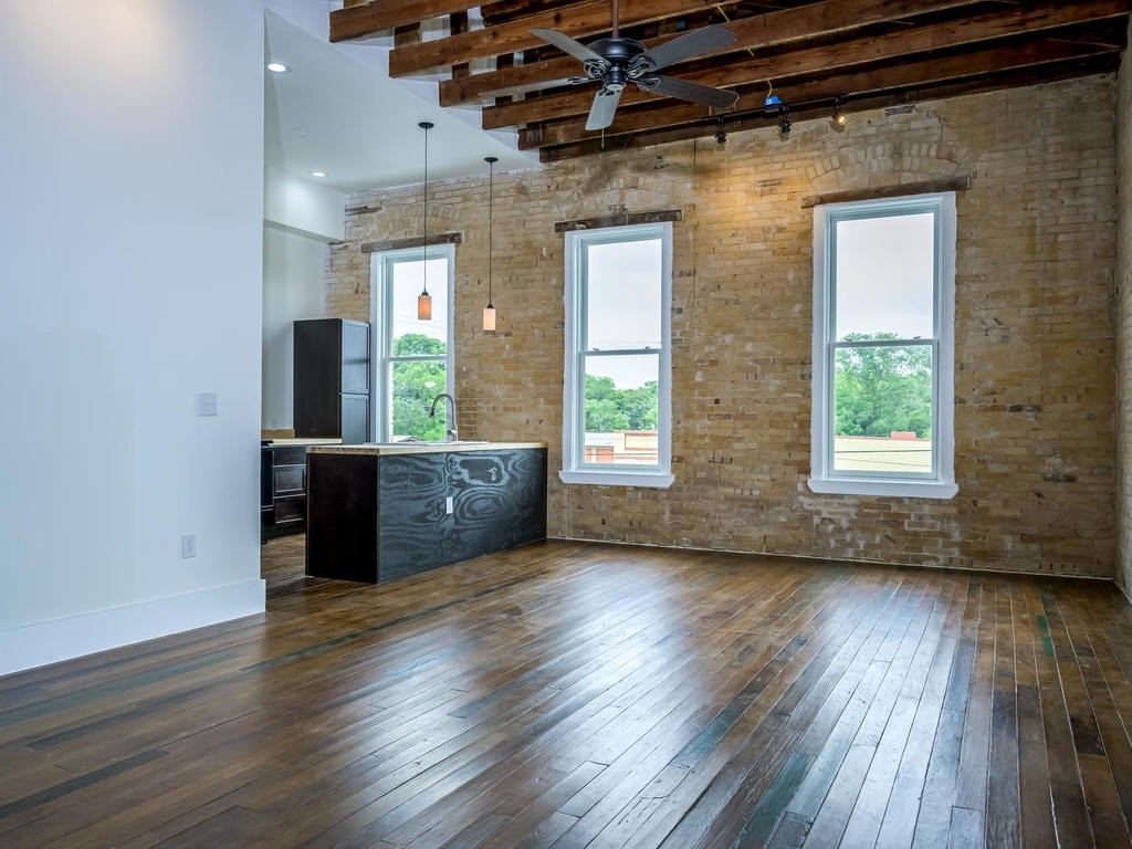 110 South Main Street, Unit 206 Elgin, TX 78621 - Photo 17 of 20 a view of an empty room with wooden floor and a window